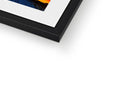 A picture frame with a photograph in a black frame sitting on top of a table.
