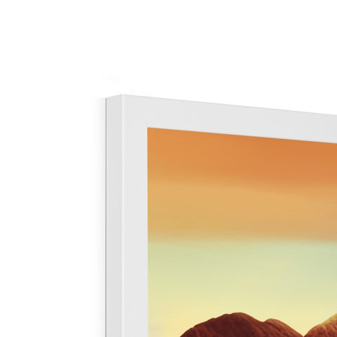 There is a picture of an iMac MacBook sitting next to a picture frame.