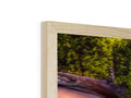 A picture photo is on top of a white frame of a piece of wood with wooden