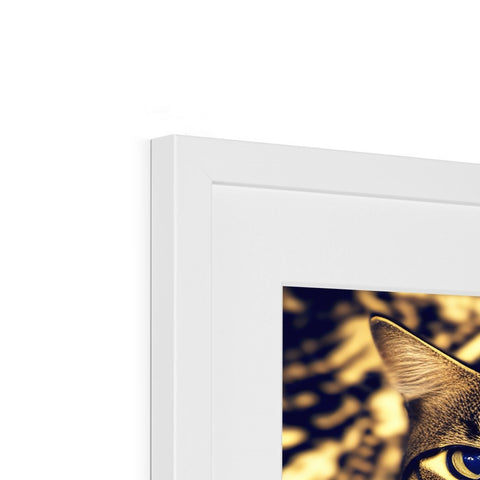 A cat looking at a picture on a photo frame of a cat with gold artwork.