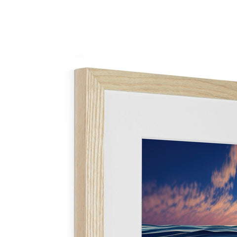 A picture of a blue sky framed in a photograph in a wooden frame.