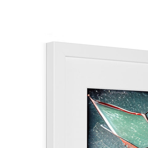 An imac is in a picture frame hanging above another picture frame.
