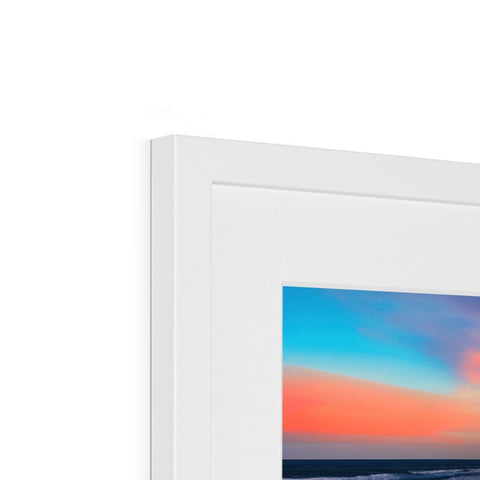 A picture of white and blue photo frames on a white wall.