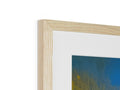 Wood framed art on a metal wall with a blue and yellow photograph.