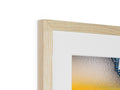 A photo of an art print is sitting on a wooden frame on top of a table