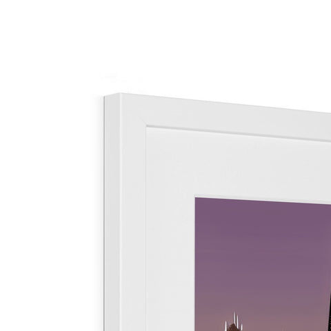 A framed photo is on a white wall of several different colors