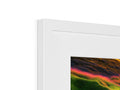 A picture frame filled with an imac screen with multiple colored images on it.