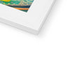 A picture frame with an abstract painting of the rainbow laying on a desk on a white