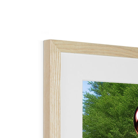 A picture frame made up of a white picture standing on top of a wood frame.