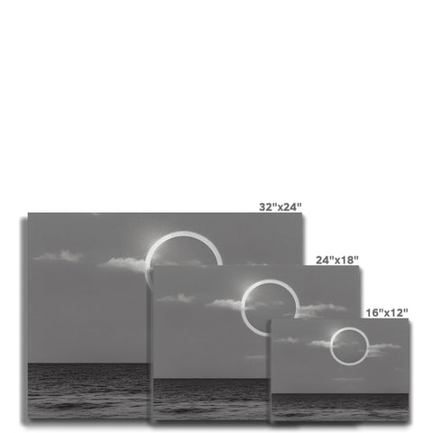 Four pictures of black and white photo of a sunrise over the ocean.