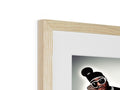 A framed picture of a black and white photo is up on a piece of wood holding