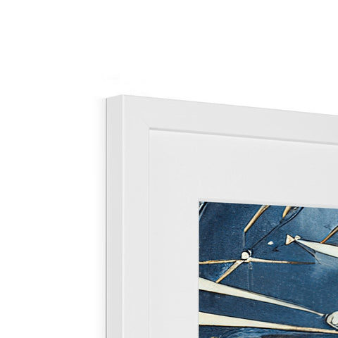 A white and blue photo frame is hanging on a wall