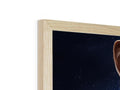 A man looking at a TV through a cardboard frame is sitting on top of a wooden