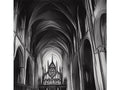A large black and white picture of an English Gothic Cathedral with a very large window at