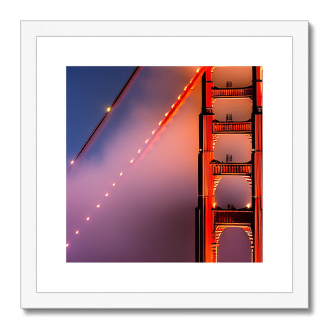 A metal framed photo of a bridge with a golden gate.
