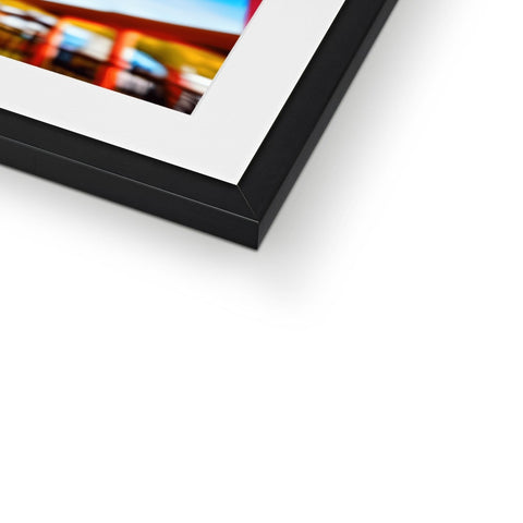 A flat panel picture in a metal frame on a black frame.