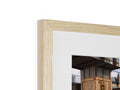 A wooden photo frame sitting on top of a wall with a mirror.