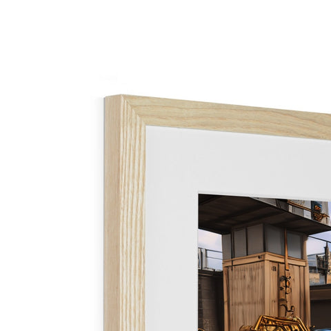 A wooden photo frame sitting on top of a wall with a mirror.