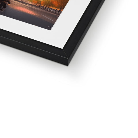 A framed photograph hanging in a picture frame near a picture of a car.