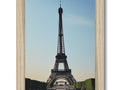 a wooden frame featuring a picture of an eiffel tower with a blue frame and