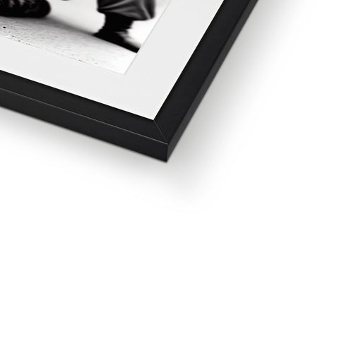 A framed photograph is placed in a white and black and white picture frame