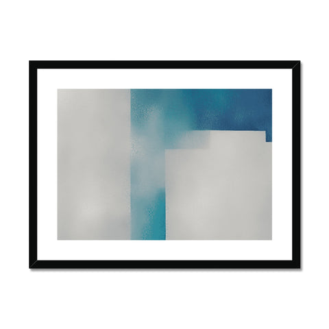 A white and black art print with cross sitting on a white frame.