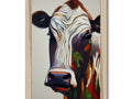 A cow has its head sticking out of an image of a wooden frame.