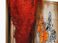 A rust colored kitchen table with the wood in a fireplace with a picture of graffiti spray