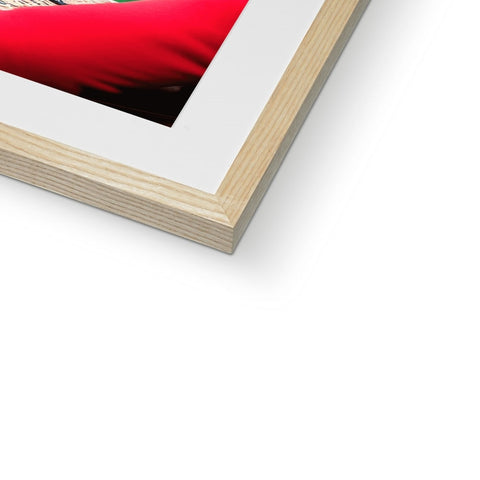 A white photo frame has a book on it of a female figure with a red flower