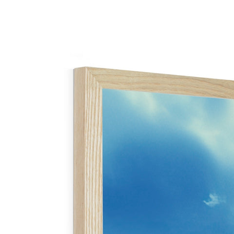 A photo frame containing an image on a shelf of wood