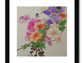 An art print featuring white floral print on a frame with pink flowers hanging inside.