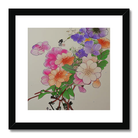 An art print featuring white floral print on a frame with pink flowers hanging inside.