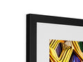 A colorful photo is in a gold framed picture frame hanging on a wall.