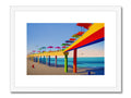 A colorful print of a lifeguard tower with ocean blue and white beach with a sunset
