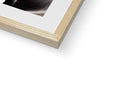 A photo of a white picture frame that is in front of a book.