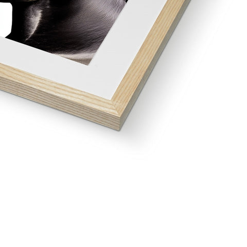 A photo of a white picture frame that is in front of a book.