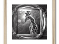 A giraffe framed photo with a black and white picture on a frame.