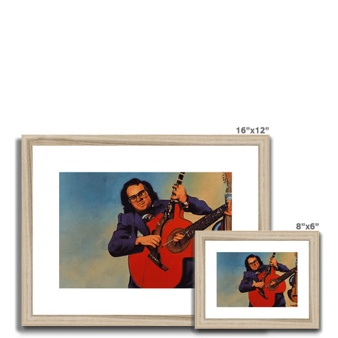 A wooden frame framed picture with a photo of a person sitting on the ground holding a