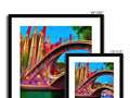 The photograph is of a colorful art print of a bridge and an arched structure.