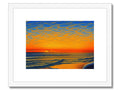 A wooden art print is decorated with a sunset looking on a beach