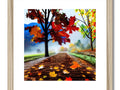 An autumn foliage picture on a wooden frame with it's fall leaves outside