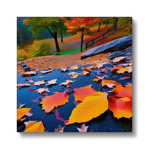 A colorful art print hanging on a light colored blanket next to a field of leaves.