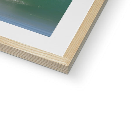 A photo of the ocean is on a wooden frame outside on a table.