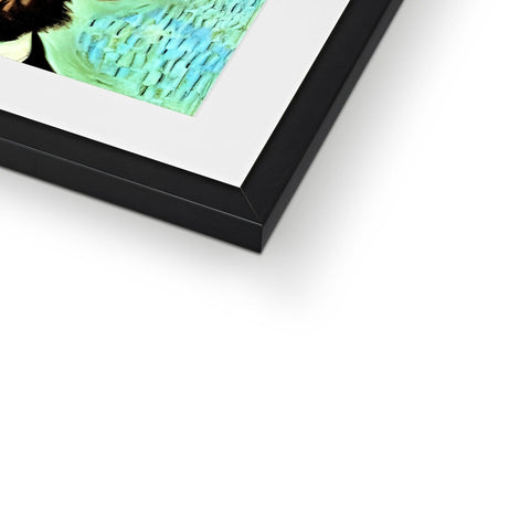 A framed image of an abstract photo of an animal on a table.