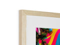 A photo is covered in a colorful frame in a wooden box.