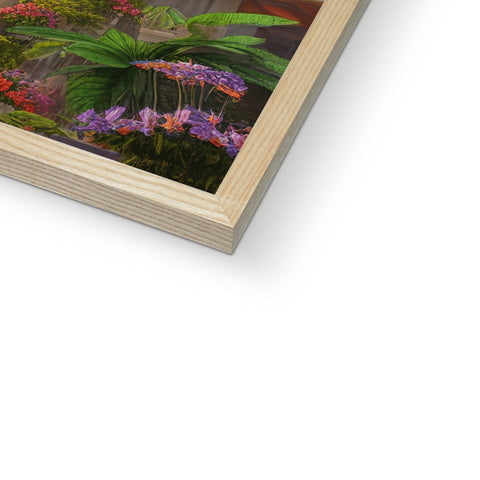 A wooden picture frame that contains various tropical plants in a color palette.