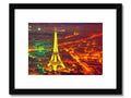 A frame of an art print of the Eiffel tower with a large sky and