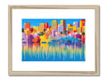 The colorful view of a city skyline from a framed print and a black framed photo of