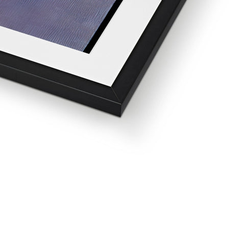 A picture frame, framed in blue and black, on top of metal top.