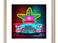 An art print of a car driving down the street in bright neon light.